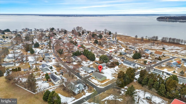 snowy aerial view with a water view