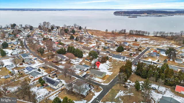 snowy aerial view with a water view