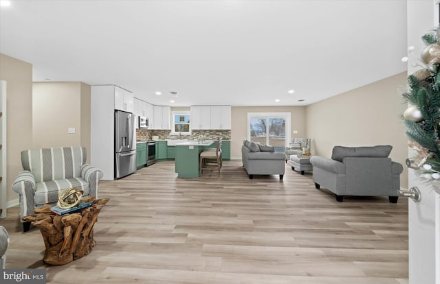 living room featuring light wood-type flooring and sink