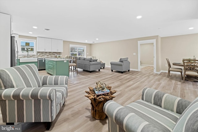 living room featuring light hardwood / wood-style floors and sink