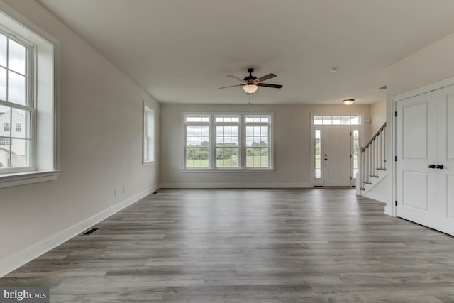 unfurnished living room with light wood-type flooring and ceiling fan