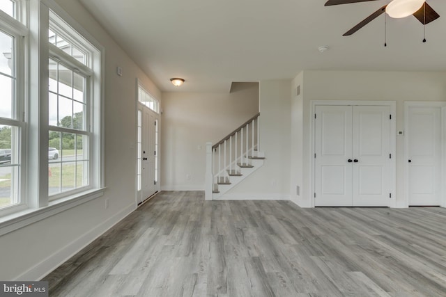 entryway with ceiling fan, plenty of natural light, and light hardwood / wood-style floors