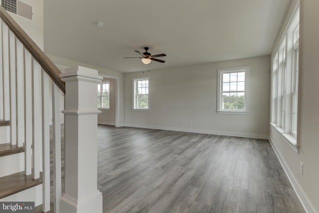 unfurnished living room featuring ceiling fan and hardwood / wood-style floors