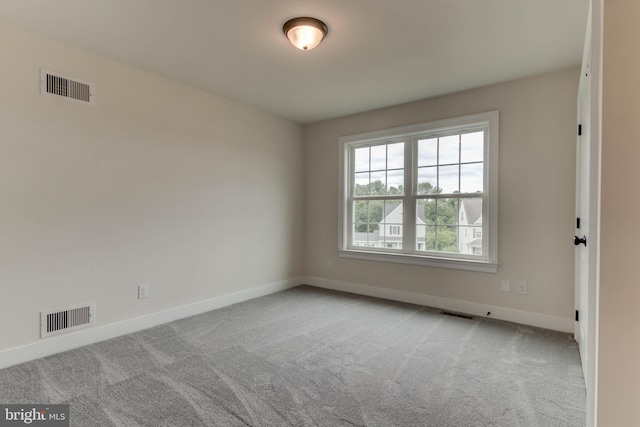 unfurnished room with light colored carpet