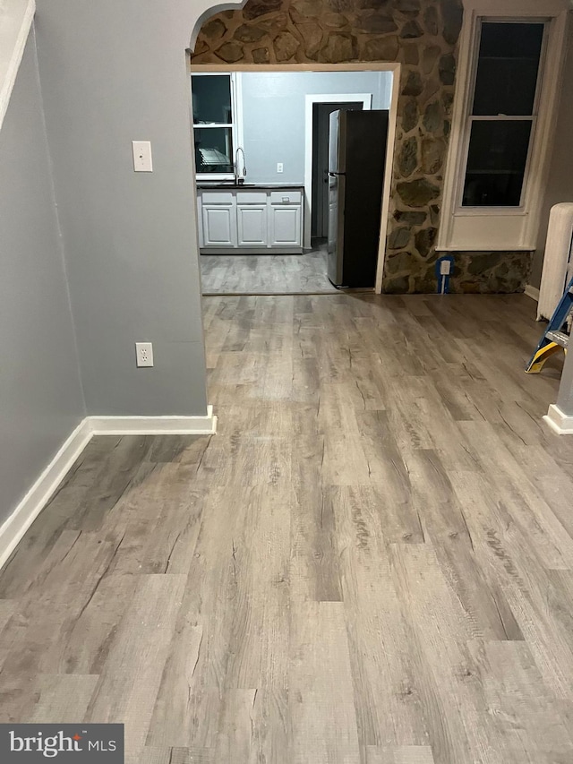 interior space with light hardwood / wood-style flooring and sink