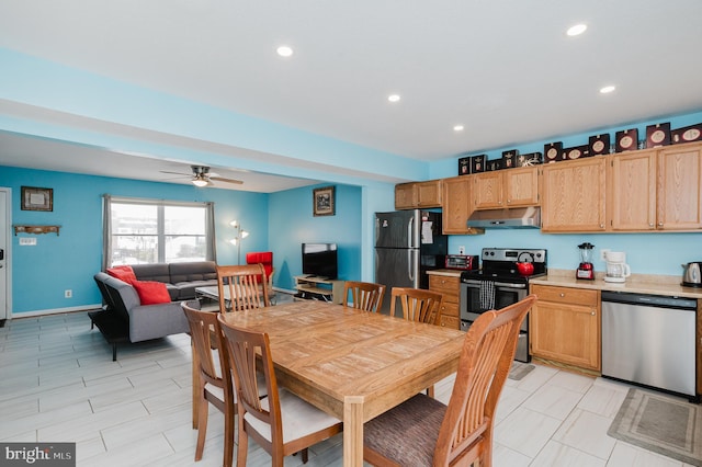 kitchen featuring light brown cabinets, ceiling fan, and appliances with stainless steel finishes