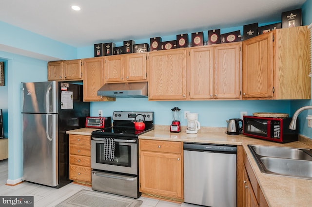 kitchen featuring sink, light brown cabinets, and appliances with stainless steel finishes