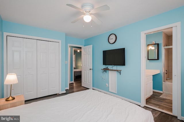 unfurnished bedroom featuring wood-type flooring, ensuite bathroom, ceiling fan, and a closet