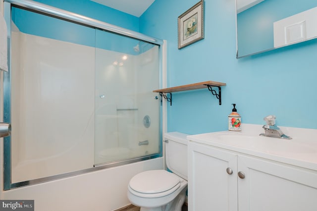 full bathroom featuring vanity, shower / bath combination with glass door, and toilet