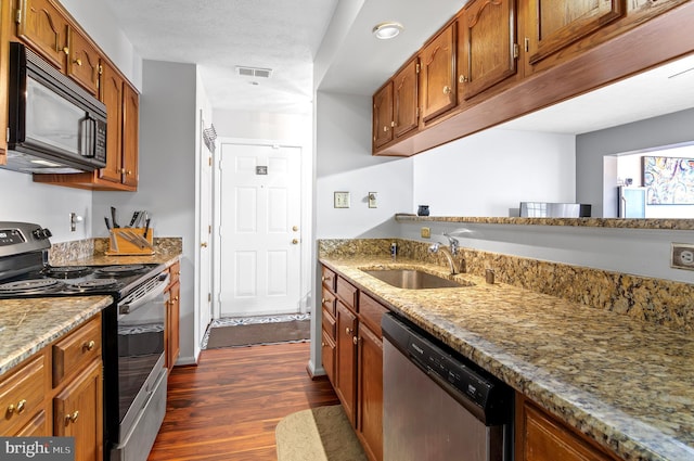 kitchen featuring dark wood-style floors, electric stove, stainless steel dishwasher, a sink, and black microwave