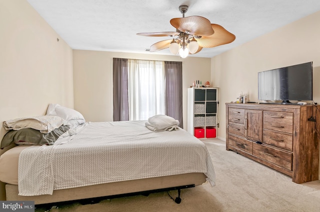 bedroom with ceiling fan and light colored carpet