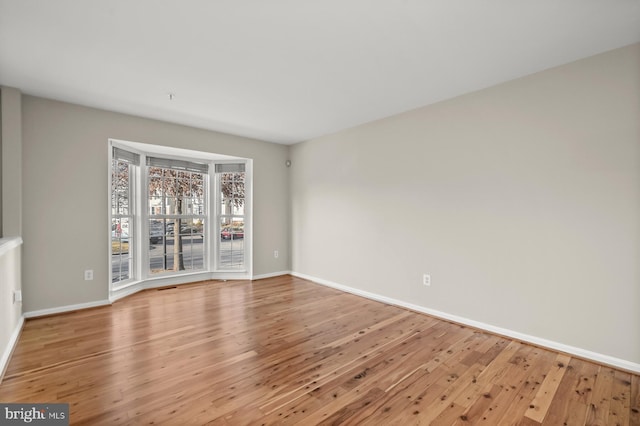 unfurnished room with light hardwood / wood-style floors