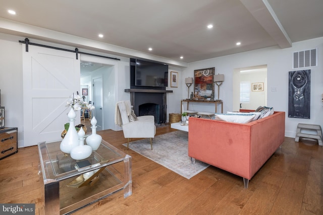 living area featuring a fireplace, hardwood / wood-style flooring, recessed lighting, and visible vents