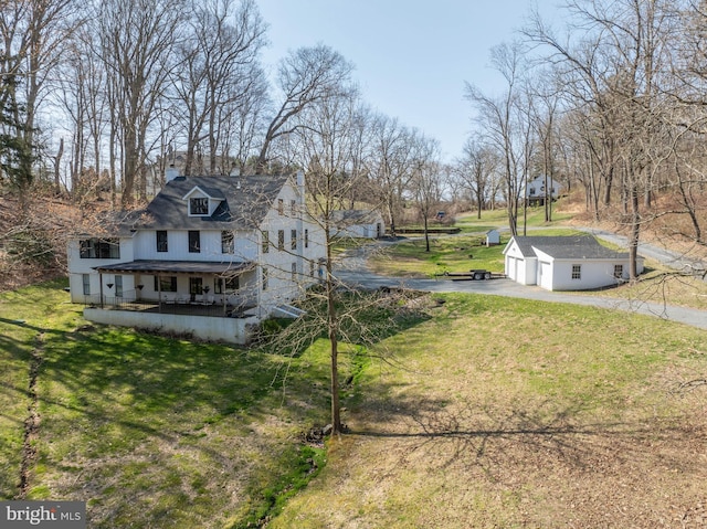 exterior space with an outdoor structure, a garage, and driveway