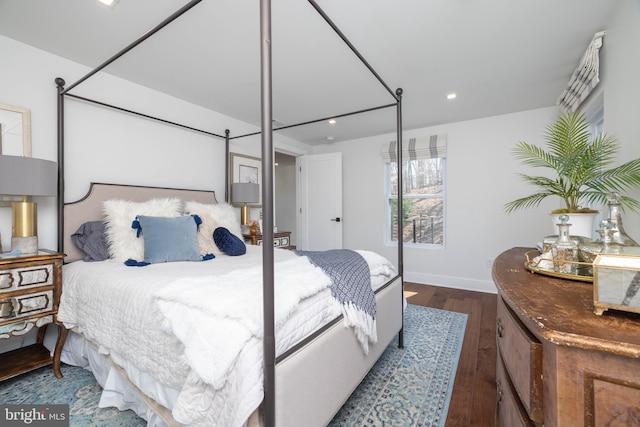 bedroom with recessed lighting, wood finished floors, and baseboards