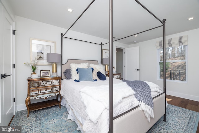 bedroom featuring wood finished floors and baseboards