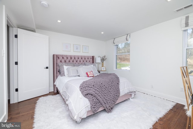 bedroom with recessed lighting, visible vents, baseboards, and wood finished floors