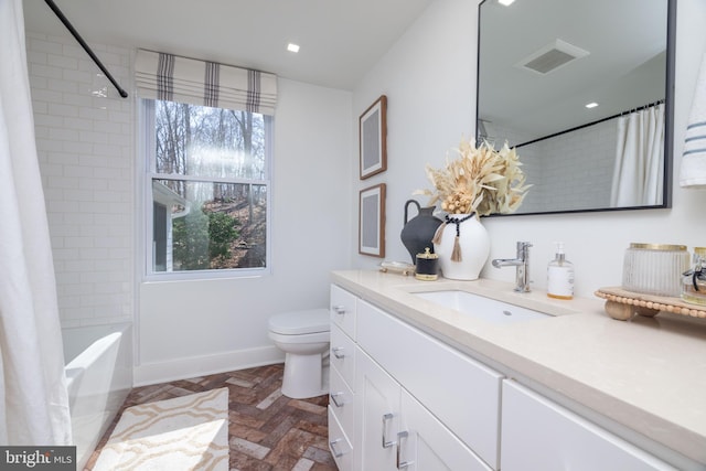 bathroom with visible vents, baseboards, toilet, shower / bath combination with curtain, and vanity