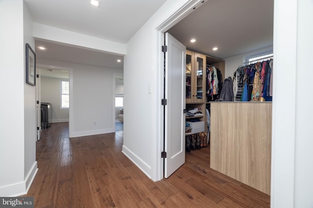 hall featuring recessed lighting, baseboards, and wood-type flooring