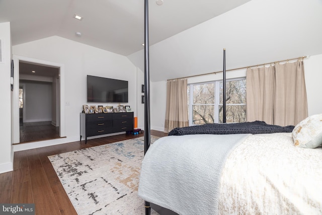 bedroom featuring vaulted ceiling, dark wood-style floors, and baseboards