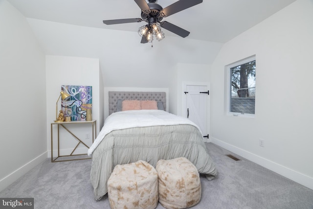 carpeted bedroom with visible vents, a ceiling fan, baseboards, and vaulted ceiling