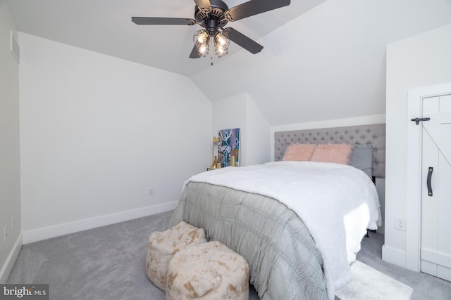 carpeted bedroom featuring baseboards, lofted ceiling, and ceiling fan