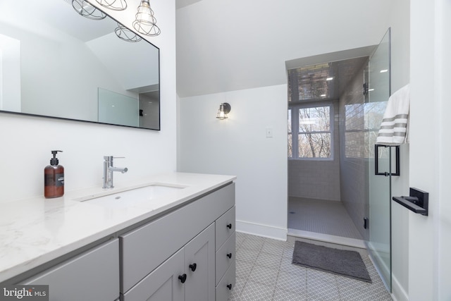 full bath featuring tile patterned floors, baseboards, a stall shower, and vanity