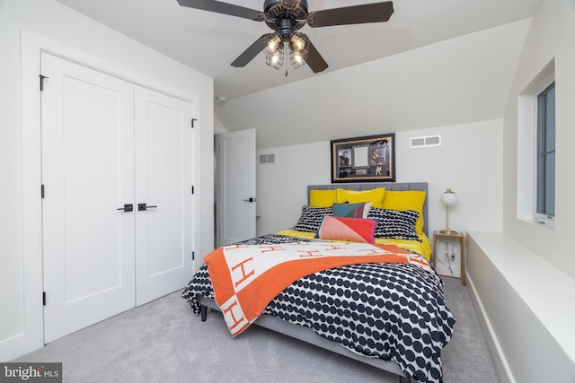 carpeted bedroom featuring visible vents, a closet, a ceiling fan, and vaulted ceiling