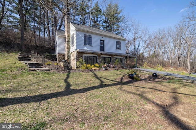 view of front of property with stone siding and a front yard