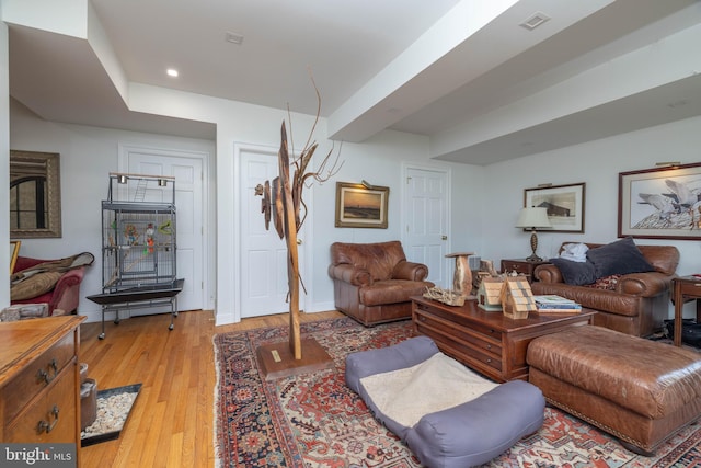 living room with recessed lighting, baseboards, and light wood-style floors