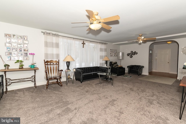 living room with ceiling fan and carpet