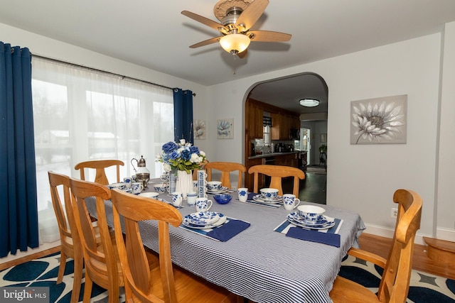 dining space featuring ceiling fan and wood-type flooring