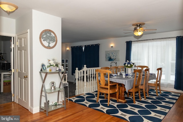 dining space featuring ceiling fan and hardwood / wood-style floors