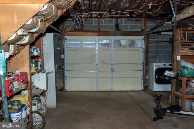 garage featuring electric panel and washer / clothes dryer