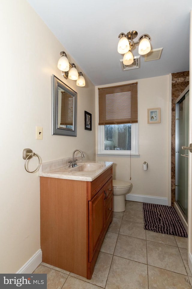 bathroom with tile patterned floors, toilet, walk in shower, and vanity