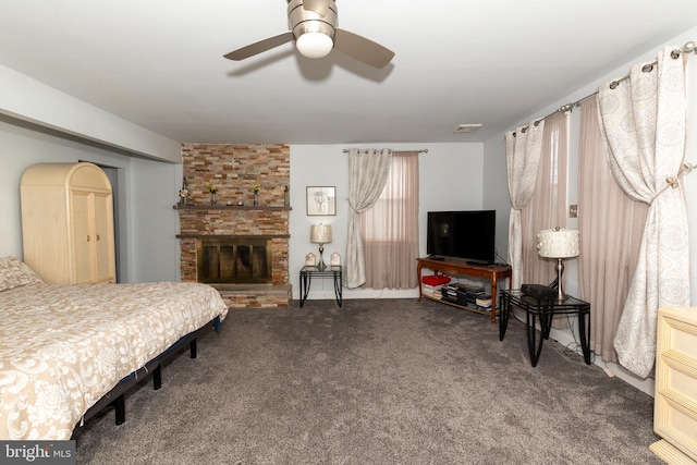 carpeted bedroom with a fireplace and ceiling fan