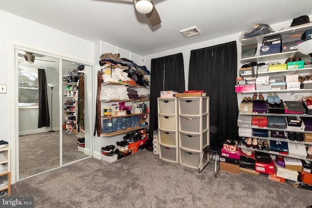 spacious closet featuring ceiling fan and carpet flooring