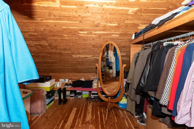 spacious closet with hardwood / wood-style floors and lofted ceiling