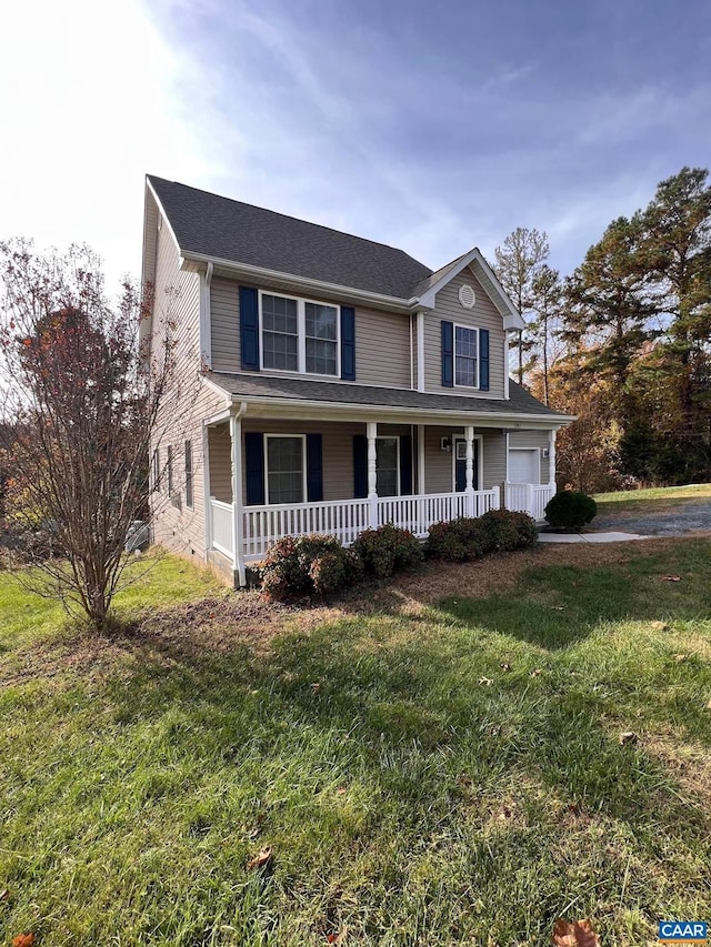 view of front facade with a front yard and a porch