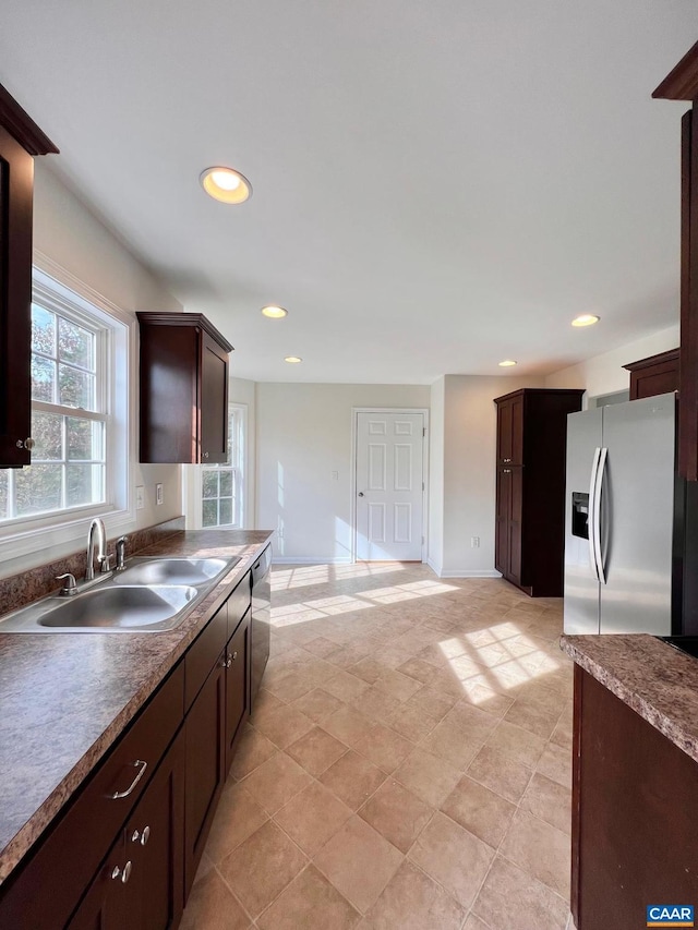 kitchen featuring stainless steel appliances, dark brown cabinets, and sink