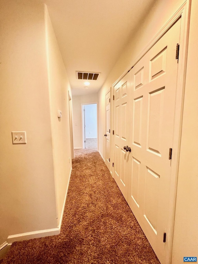 hallway with carpet flooring