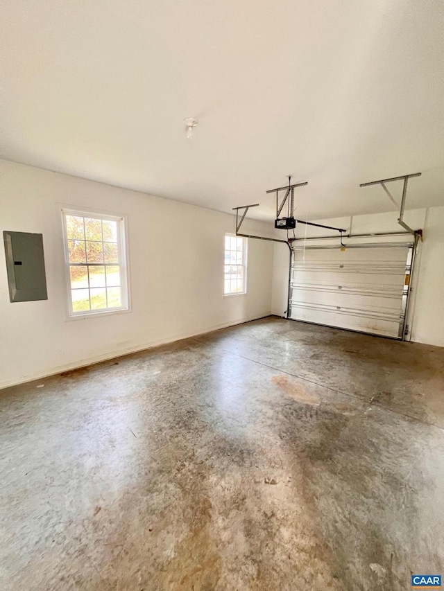 garage with a garage door opener and electric panel