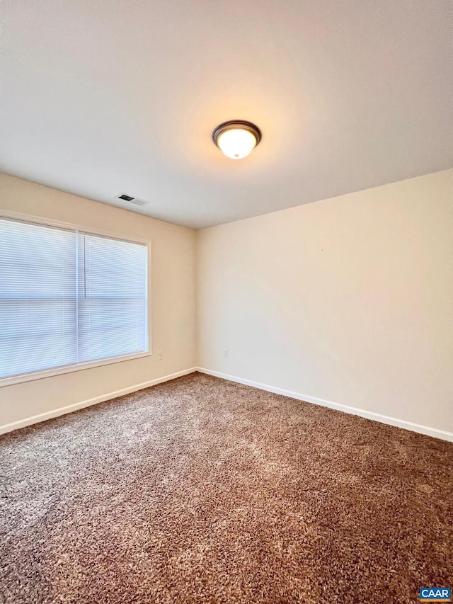 spare room featuring carpet floors