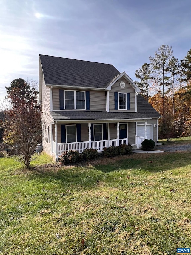 view of property with a front lawn, a garage, and a porch