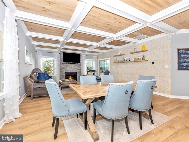 dining room with coffered ceiling, wooden ceiling, a fireplace, and light hardwood / wood-style floors