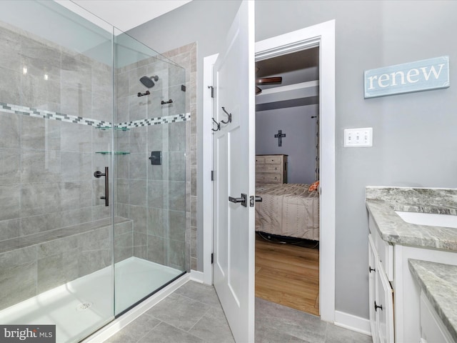 bathroom featuring tile patterned flooring, vanity, and an enclosed shower