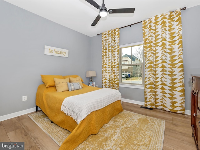 bedroom with light wood-type flooring and ceiling fan