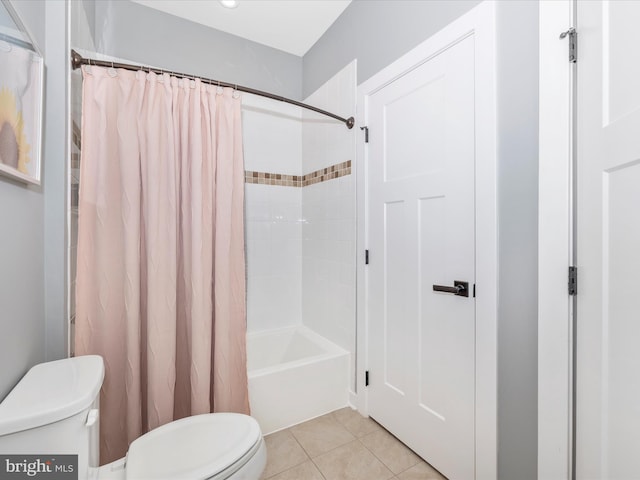 bathroom featuring tile patterned floors, toilet, and shower / tub combo