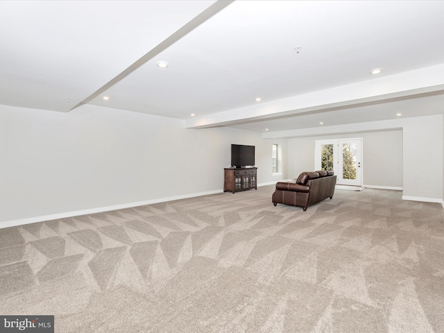 unfurnished room featuring beam ceiling, french doors, and light colored carpet