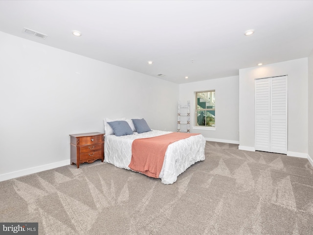 bedroom featuring light carpet and a closet